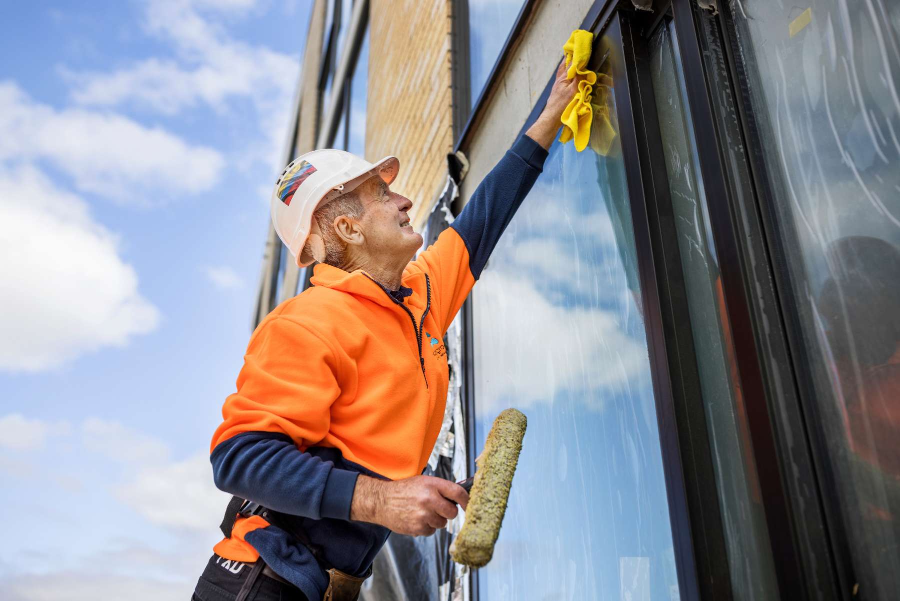 Man Cleaning the window of the building